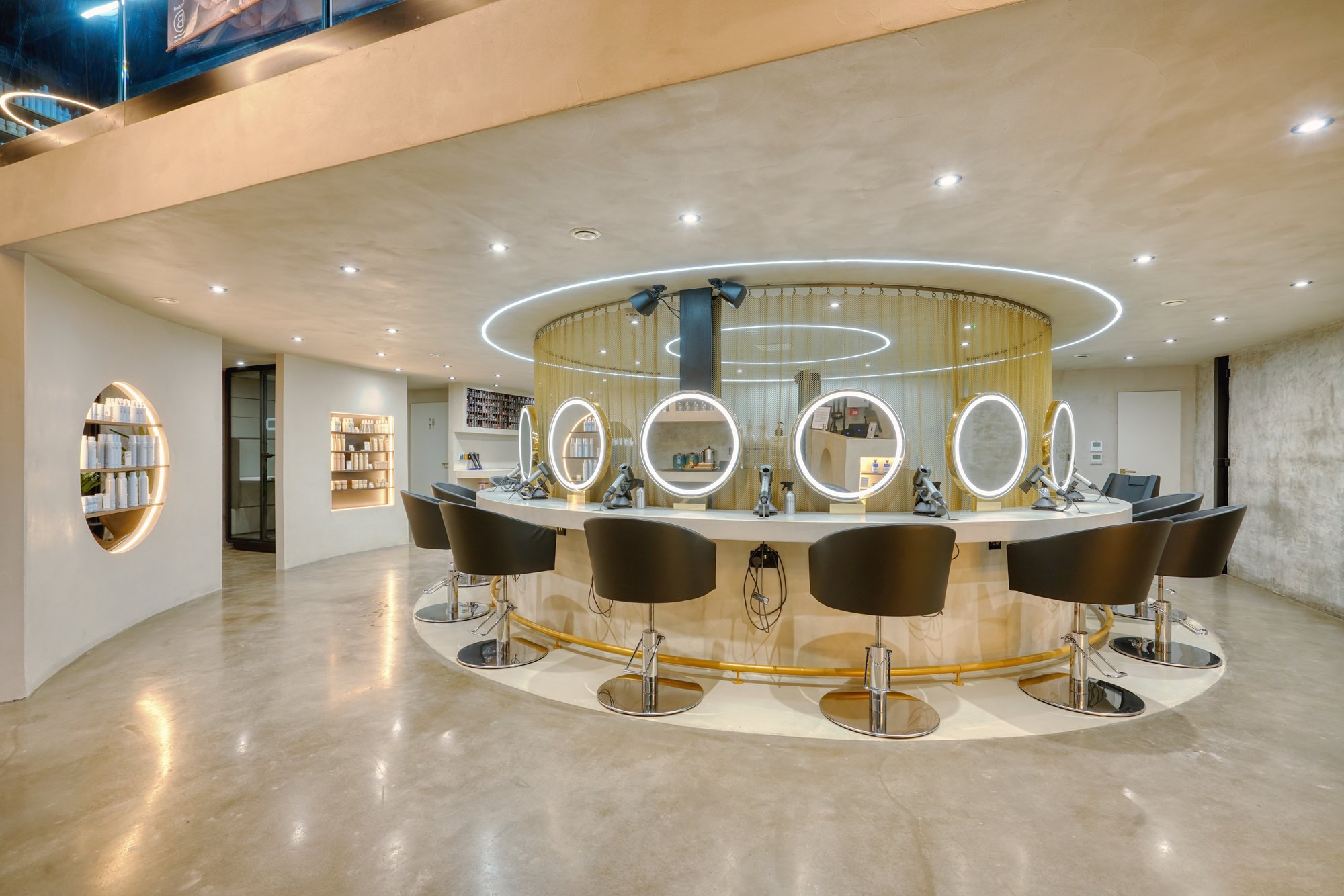Circular styling station with ring-lit mirrors at Avesta Hair, Salford
